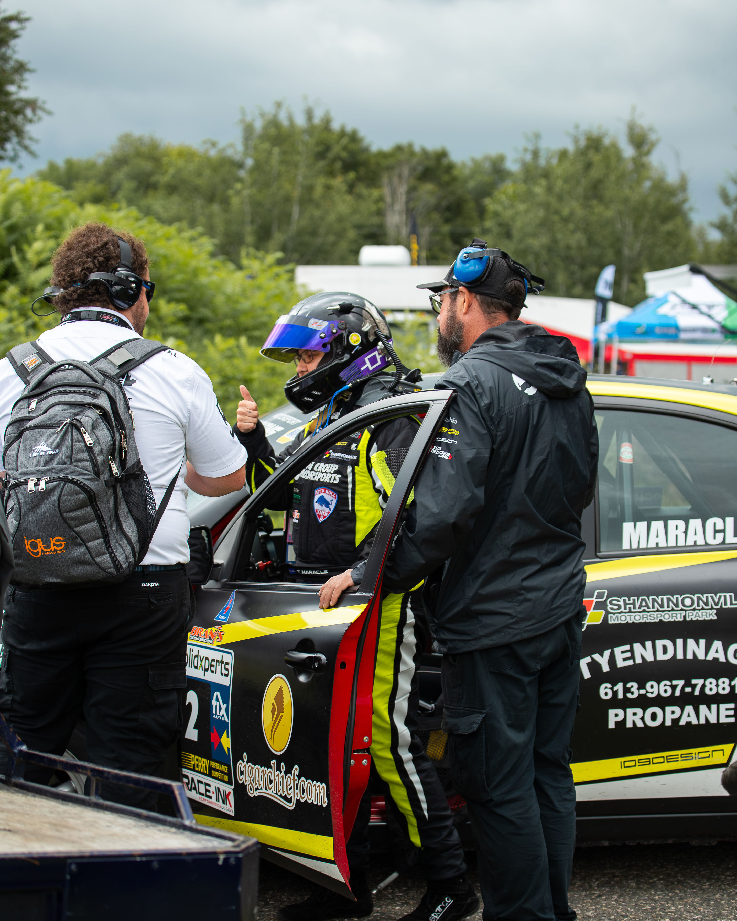 Tamara conferring with her pit crew and giving thumbs up before heading out